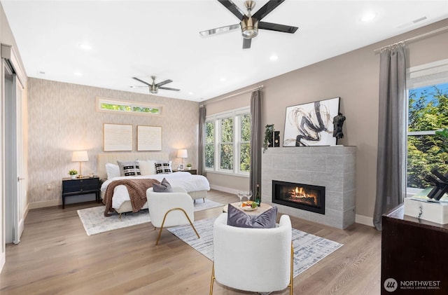 2222 E Mcgraw St, Seattle, WA 98112 - bedroom with baseboards, a tiled fireplace, wallpapered walls, recessed lighting, and light wood finished floors