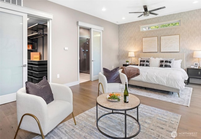 2222 E Mcgraw St, Seattle, WA 98112 - bedroom with wallpapered walls, wood finished floors, baseboards, ensuite bath, and recessed lighting