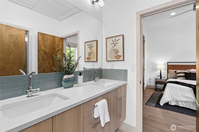 2222 E Mcgraw St, Seattle, WA 98112 - bathroom featuring ensuite bathroom, double vanity, wood finished floors, and baseboards