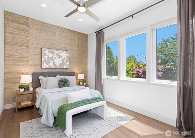 2222 E Mcgraw St, Seattle, WA 98112 - bedroom featuring an accent wall, baseboards, recessed lighting, wood finished floors, and wooden walls