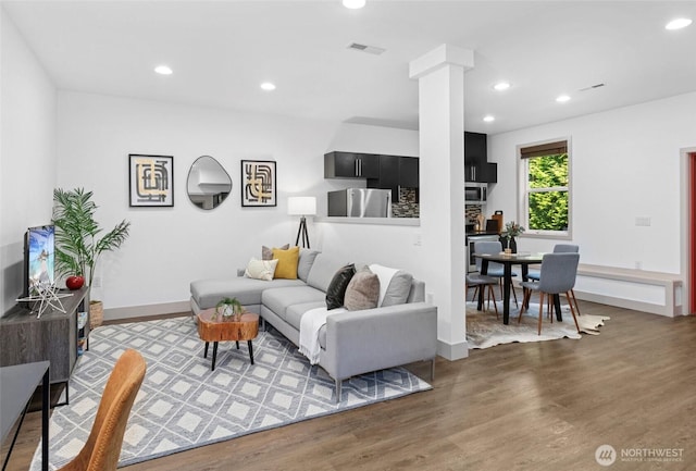 2222 E Mcgraw St, Seattle, WA 98112 - living area featuring ornate columns, wood finished floors, recessed lighting, and baseboards