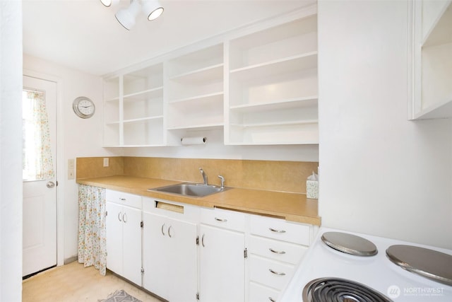 168 Union St, Walla Walla, WA 99362 - kitchen with open shelves, stove, a sink, and white cabinets