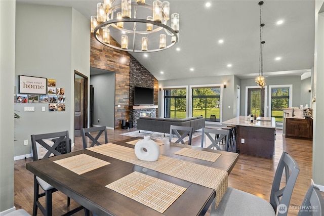 1550 Old Cedars Rd, Cle Elum, WA 98922 - dining space featuring healthy amount of natural light, wood finished floors, a chandelier, recessed lighting, and high vaulted ceiling