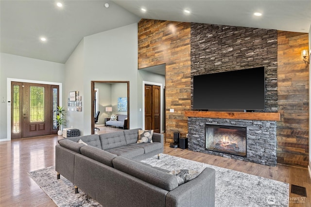 1550 Old Cedars Rd, Cle Elum, WA 98922 - living area with high vaulted ceiling, a stone fireplace, and wood finished floors