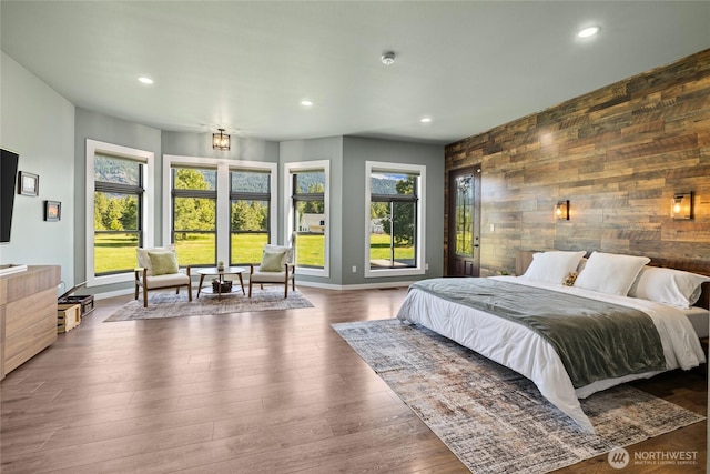 1550 Old Cedars Rd, Cle Elum, WA 98922 - bedroom with wooden walls, recessed lighting, an accent wall, baseboards, and wood finished floors