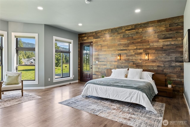 1550 Old Cedars Rd, Cle Elum, WA 98922 - bedroom with an accent wall, baseboards, recessed lighting, wood walls, and wood finished floors