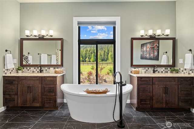 1550 Old Cedars Rd, Cle Elum, WA 98922 - full bathroom with marble look tile flooring, two vanities, and a freestanding tub