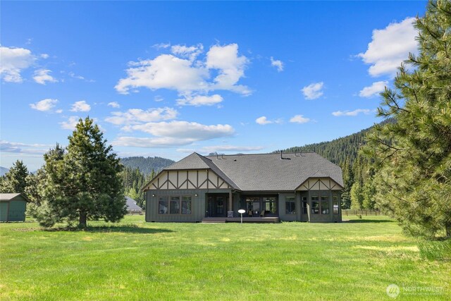1550 Old Cedars Rd, Cle Elum, WA 98922 - rear view of house with a lawn, a sunroom, and a shingled roof