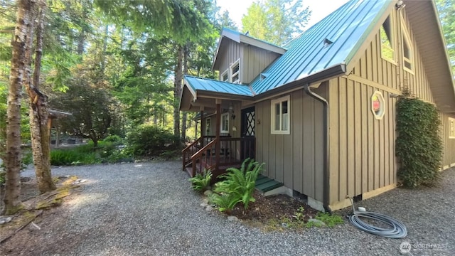 321 N Lake Surf Dr, Lilliwaup, WA 98555 - view of home's exterior featuring a metal roof, a standing seam roof, and board and batten siding