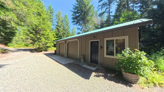 321 N Lake Surf Dr, Lilliwaup, WA 98555 - view of front of property featuring board and batten siding and a metal roof