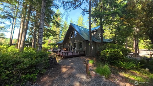 321 N Lake Surf Dr, Lilliwaup, WA 98555 - view of side of home with board and batten siding, a wooden deck, and a metal roof