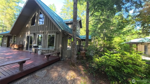 321 N Lake Surf Dr, Lilliwaup, WA 98555 - back of house featuring board and batten siding, a metal roof, a standing seam roof, and a deck