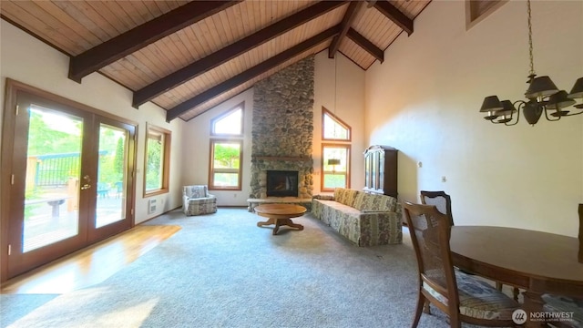 321 N Lake Surf Dr, Lilliwaup, WA 98555 - living room featuring a wood ceiling with exposed beams, a chandelier, high vaulted ceiling, carpet floors, and a stone fireplace