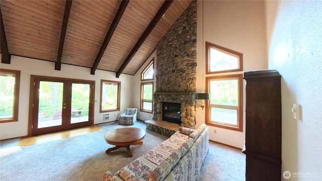 321 N Lake Surf Dr, Lilliwaup, WA 98555 - carpeted living room with a wooden ceiling with exposed beams, a stone fireplace, high vaulted ceiling, and french doors
