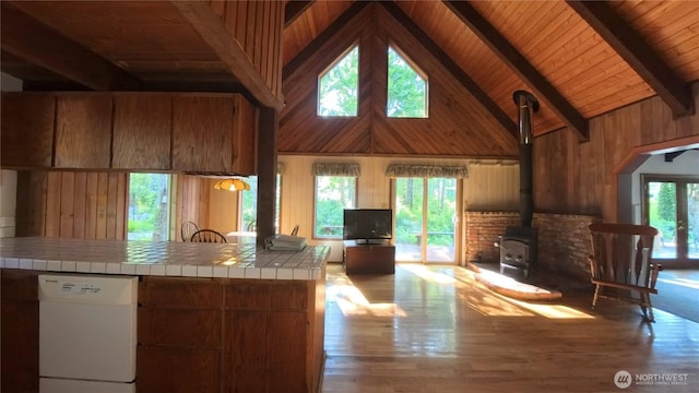 321 N Lake Surf Dr, Lilliwaup, WA 98555 - kitchen featuring dishwasher, a wood stove, high vaulted ceiling, tile countertops, and brown cabinetry