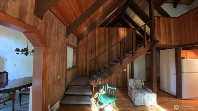 321 N Lake Surf Dr, Lilliwaup, WA 98555 - stairs featuring a chandelier, wood walls, wood finished floors, and wood ceiling