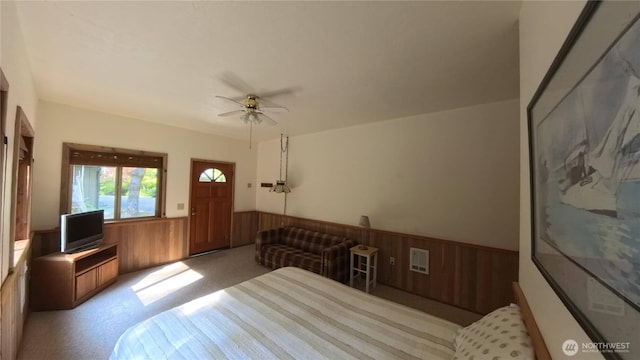 321 N Lake Surf Dr, Lilliwaup, WA 98555 - carpeted bedroom featuring a wainscoted wall, wooden walls, and ceiling fan