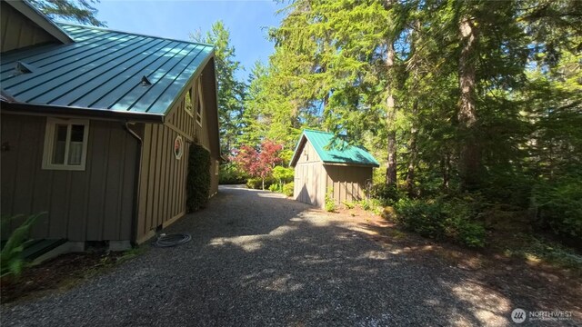 321 N Lake Surf Dr, Lilliwaup, WA 98555 - view of home's exterior featuring a standing seam roof, a metal roof, and board and batten siding