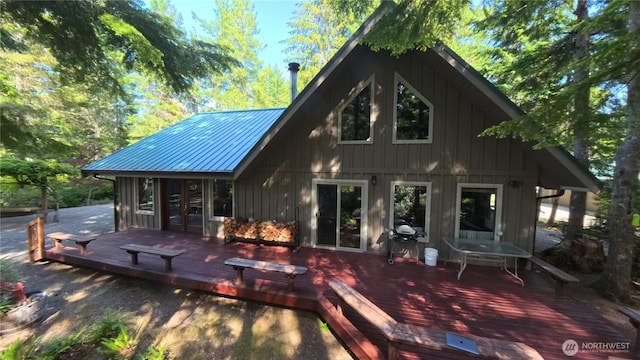 321 N Lake Surf Dr, Lilliwaup, WA 98555 - rear view of house featuring a deck, a metal roof, board and batten siding, and french doors