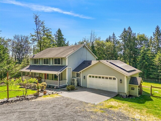 114 Black Bear Ln, Centralia, WA 98531 - view of front of house with a porch, gravel driveway, a garage, and solar panels
