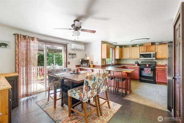 114 Black Bear Ln, Centralia, WA 98531 - dining room featuring a wall mounted air conditioner, ceiling fan, and wood finished floors