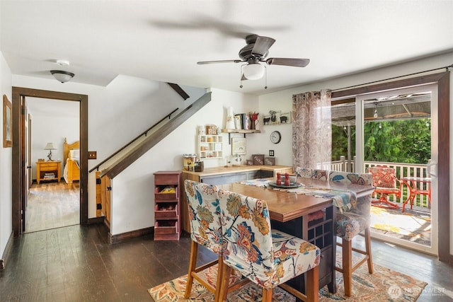 114 Black Bear Ln, Centralia, WA 98531 - dining space with dark wood-style flooring, ceiling fan, baseboards, and stairs