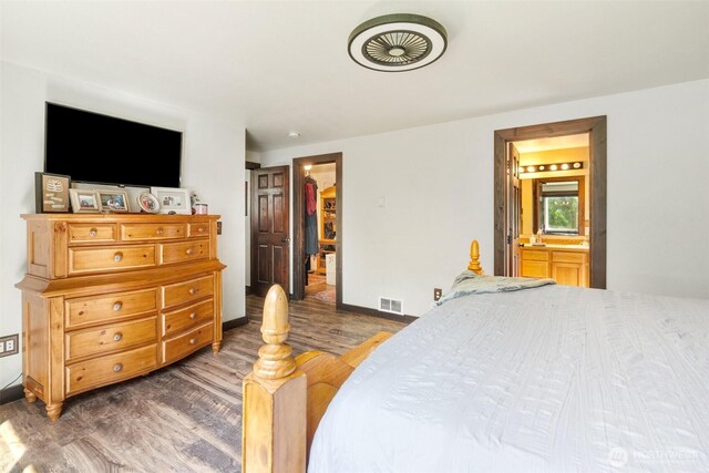 114 Black Bear Ln, Centralia, WA 98531 - bedroom featuring wood finished floors, baseboards, a spacious closet, and ensuite bathroom