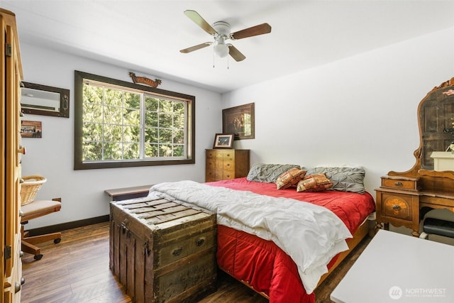 114 Black Bear Ln, Centralia, WA 98531 - bedroom featuring wood finished floors, baseboards, a wall mounted AC, and a ceiling fan