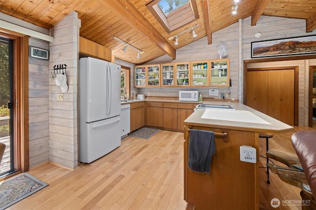 606 E Pointes Dr W, Shelton, WA 98584 - kitchen featuring white appliances, track lighting, wooden walls, wood ceiling, and a skylight