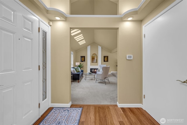 17620 NE 29th St, Redmond, WA 98052 - entryway featuring wood finished floors, baseboards, lofted ceiling, and carpet floors