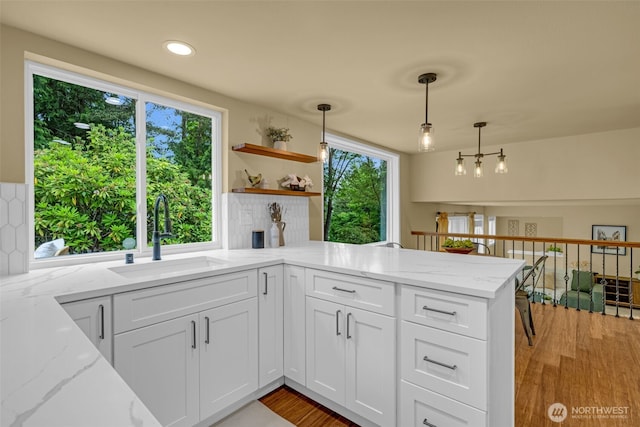 17620 NE 29th St, Redmond, WA 98052 - kitchen featuring a sink, a peninsula, open shelves, white cabinets, and pendant lighting
