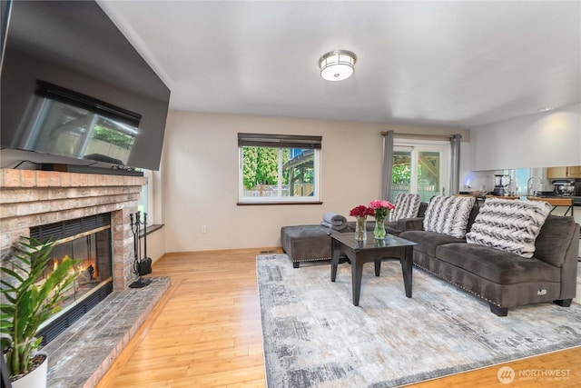 27742 214th Ave SE, Maple Valley, WA 98038 - living room featuring a brick fireplace and wood finished floors