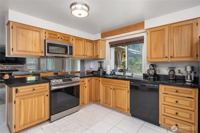 27742 214th Ave SE, Maple Valley, WA 98038 - kitchen with stainless steel appliances, a peninsula, a sink, light tile patterned floors, and dark stone counters
