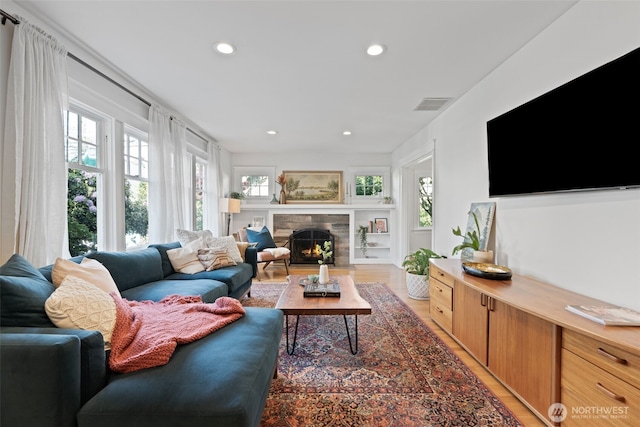 2902 N 22nd, Tacoma, WA 98406 - living area featuring plenty of natural light, light wood-type flooring, recessed lighting, and a warm lit fireplace