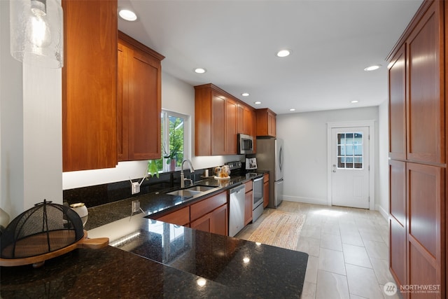 2902 N 22nd, Tacoma, WA 98406 - kitchen with a sink, appliances with stainless steel finishes, brown cabinets, recessed lighting, and dark stone countertops