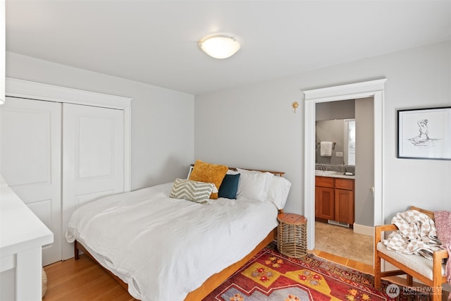 2902 N 22nd, Tacoma, WA 98406 - bedroom featuring light wood-style floors, a closet, and ensuite bath