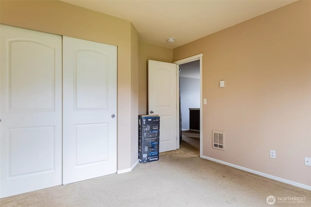 570 Beaver Blvd Unit A, Pacific, WA 98047 - unfurnished bedroom featuring light colored carpet, baseboards, and a closet