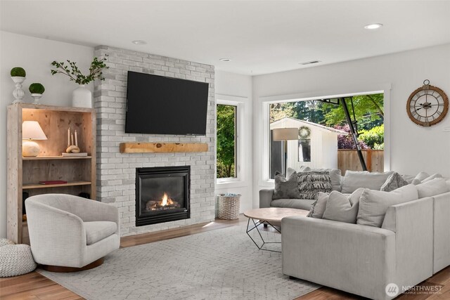9814 36th St E, Edgewood, WA 98371 - living area with a fireplace, wood finished floors, and recessed lighting