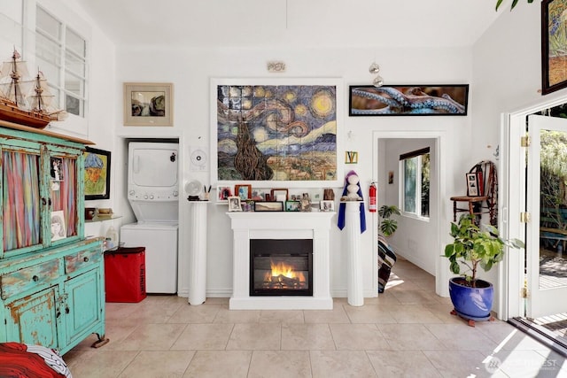 1713 Pebble Beach Trl, Bellingham, WA 98226 - living area featuring estacked washer and dryer, a glass covered fireplace, and light tile patterned floors