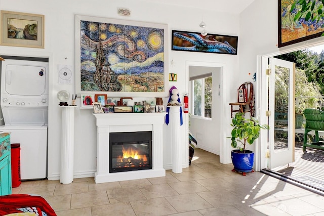 1713 Pebble Beach Trl, Bellingham, WA 98226 - living room with estacked washer and dryer, healthy amount of natural light, a glass covered fireplace, and tile patterned floors