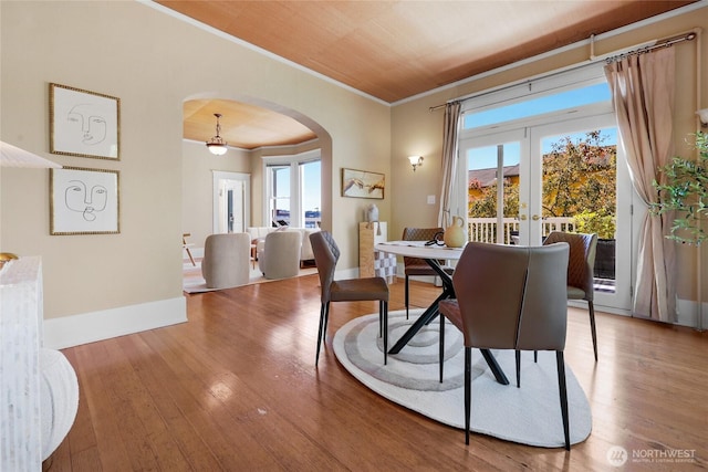 920 4th Ave N, Seattle, WA 98109 - dining room featuring arched walkways, crown molding, hardwood / wood-style flooring, french doors, and baseboards