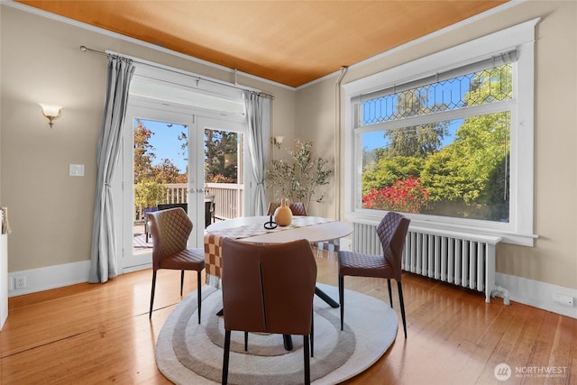 920 4th Ave N, Seattle, WA 98109 - dining room featuring radiator, plenty of natural light, light wood finished floors, and ornamental molding