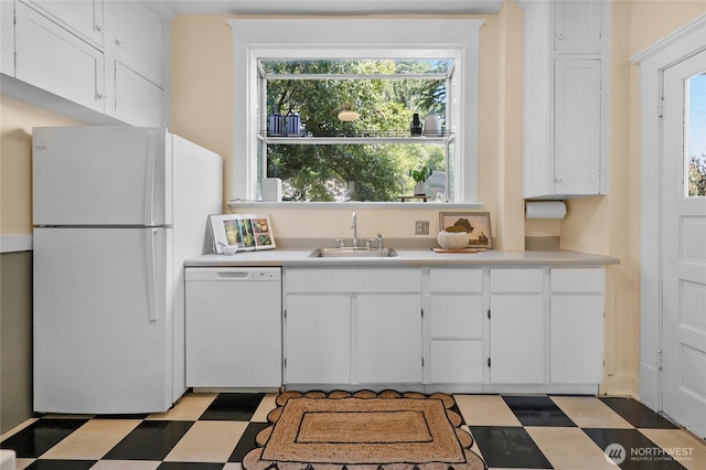 920 4th Ave N, Seattle, WA 98109 - kitchen with white appliances, a sink, light flooring, and white cabinetry