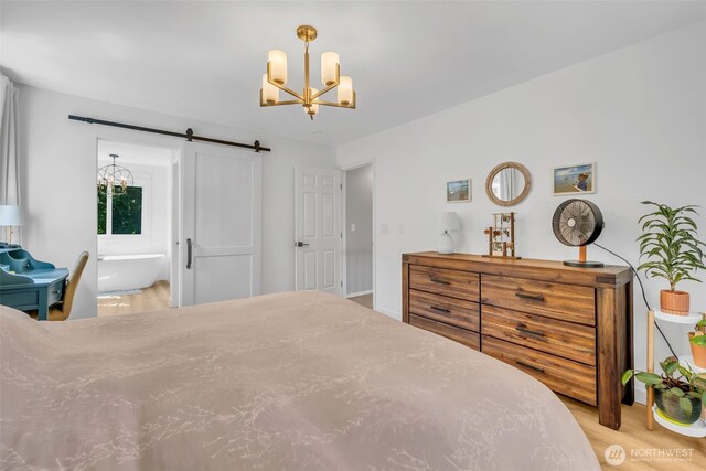 25161 13th Ave S, Des Moines, WA 98198 - bedroom with a chandelier, a barn door, and wood finished floors