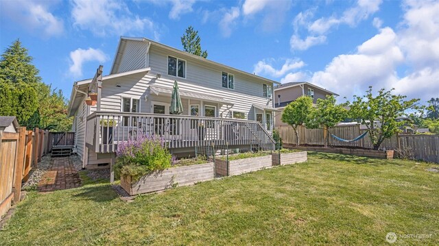 25161 13th Ave S, Des Moines, WA 98198 - rear view of house featuring a vegetable garden and a deck