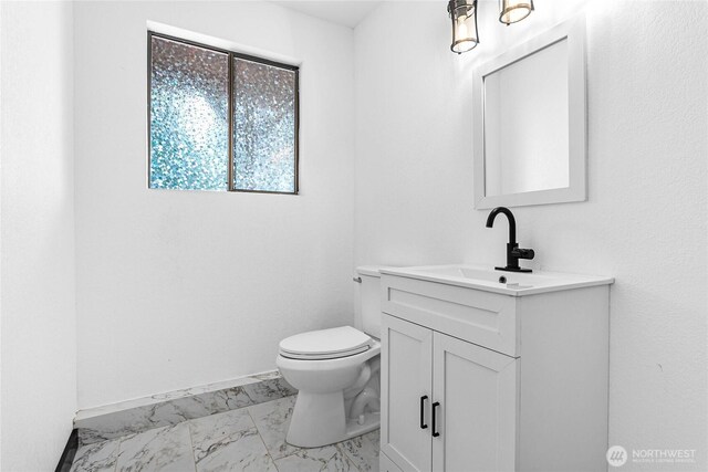 1668 Sapphire Trl, Bellingham, WA 98226 - half bathroom with marble look tiles, vanity, toilet, and baseboards