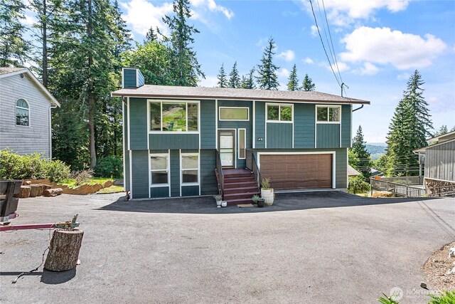 1668 Sapphire Trl, Bellingham, WA 98226 - bi-level home with asphalt driveway, a chimney, and a garage