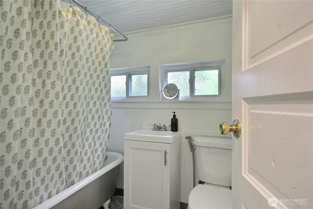 719 N 92nd St, Seattle, WA 98103 - full bathroom featuring toilet, shower / bath combo with shower curtain, vanity, and crown molding