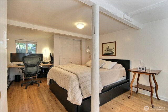 719 N 92nd St, Seattle, WA 98103 - bedroom featuring wood finished floors, beam ceiling, a closet, and an office area