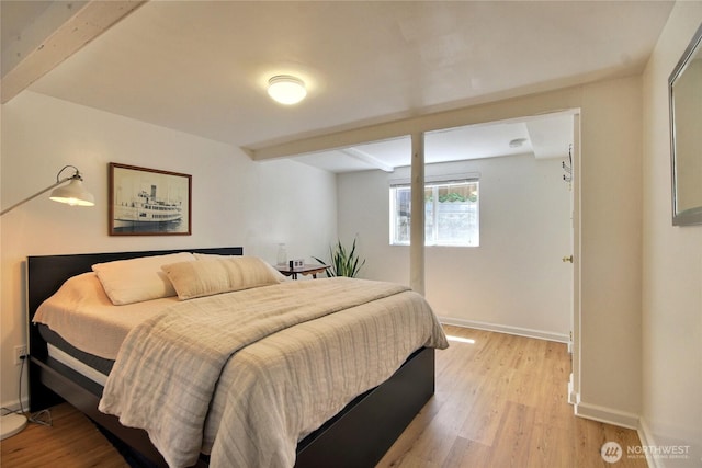 719 N 92nd St, Seattle, WA 98103 - bedroom with beamed ceiling, light wood finished floors, and baseboards